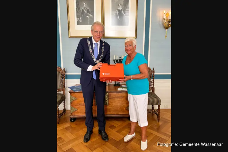 Burgemeester De Lange overhandigt nieuwe EHBO-koffer aan hulpverlener